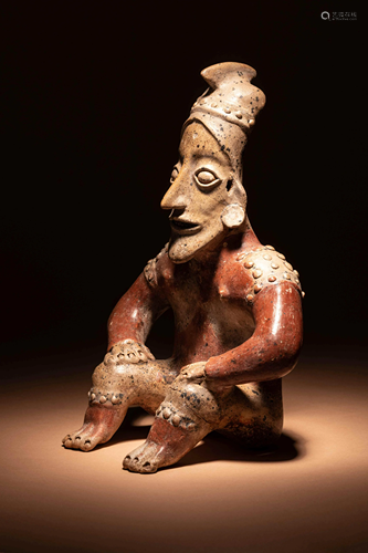 A Jalisco Terracotta Seated Figure Height 13 inches.