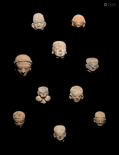 A Group of Ten Tumaco Terracotta Heads Height of