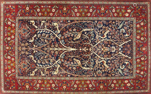 Rectangular Persian rug decorated with birds amongst