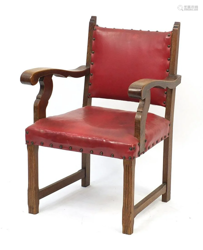 Carved oak framed chair with red leather upholstery,