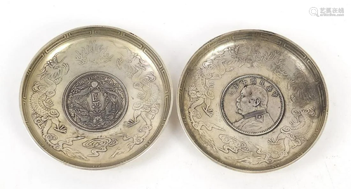 Two Chinese silver coloured metal coins dishes, each