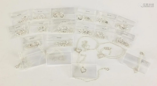 Collection of silver love heart and bow pendants on