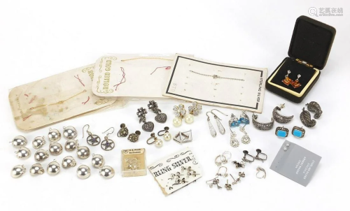 Twelve pairs of silver earrings, some set with semi
