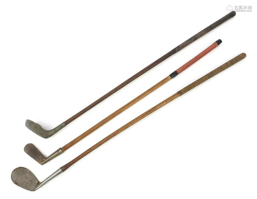 Three wooden shafted golf clubs including aluminum