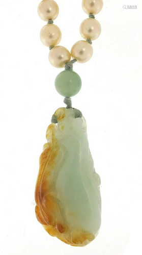 Chinese jade pendant carved with a dragon on a jade and