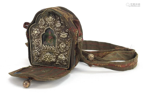 Tibetan travelling shrine with embossed silver coloured