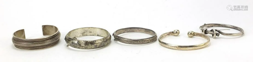 Five Victorian and later silver bangles, some with