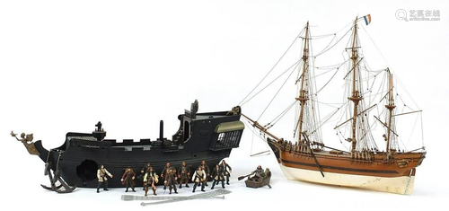 Wooden model boat and a Pirates of the Caribbean boat