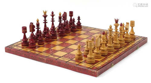 Carved hardwood chess set with folding chess board, the