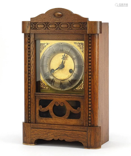 Carved oak mantle clock with silvered chapter ring