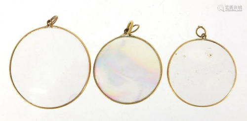 Three unmarked gold circular glass pendants (all tests