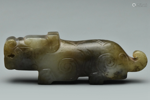 A HAN DYNASTY JADE FIGURE OF A MYTHICAL BEAST