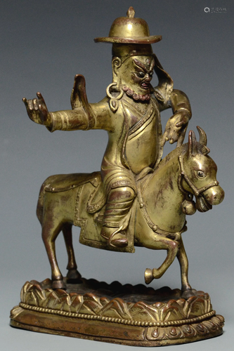 A QING DYNASTY GILT BRONZE FIGURE OF GARWA NAGPO