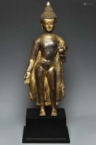 A LARGE YUAN DYNASTY GILT BRONZE FIGURE OF BUDDHA