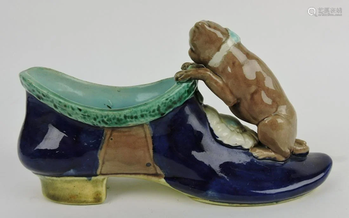 Majolica dog on shoe vase, 8