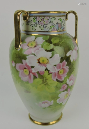 Nippon tri-handled vase with floral motif,