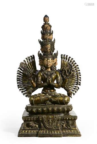 A gilt copper sitting thousand-armed Guanyin statue