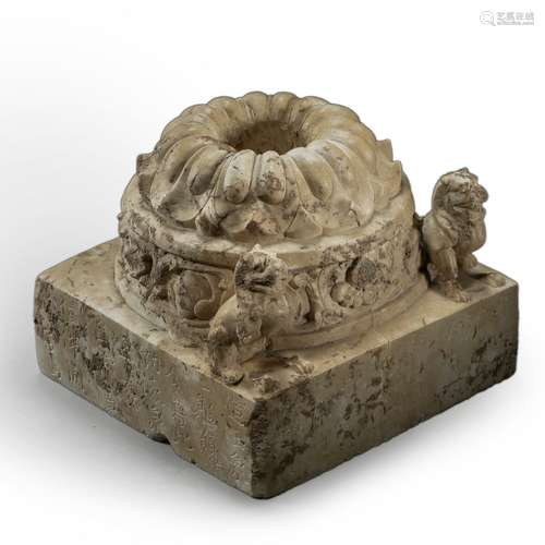 A stone carved buddha pedestal