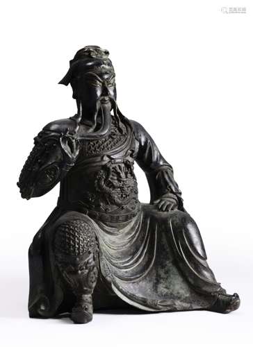 A copper sitting Guangong statue