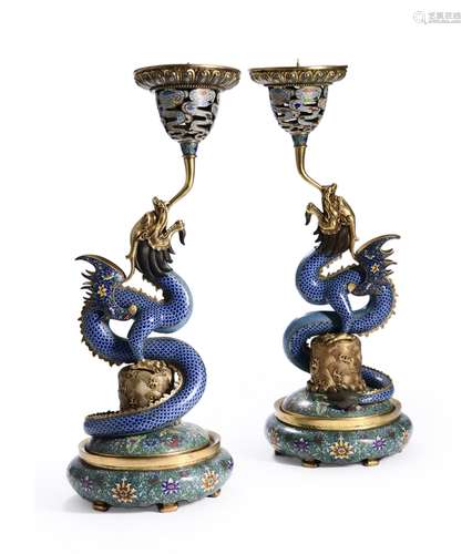 A pair of dragon shaped cloisonne enamel candlesticks