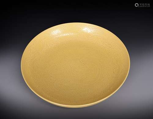 A dragon carved yellow glazed porcelain plate