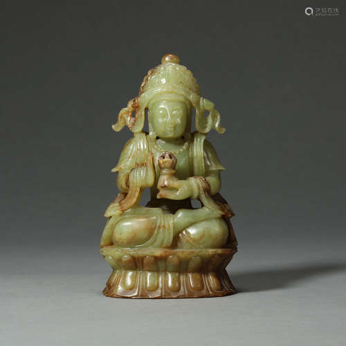 A CARVED CELADON AND RUSSET SEATED BODHISATTVA