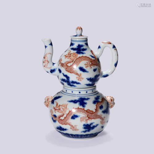 AN UNDERGLAZE BLUE AND IRON RED DRAGON EWER