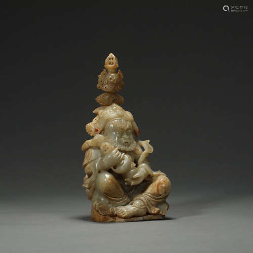 A CARVED WHITE JADE SEATED PROTECTOR