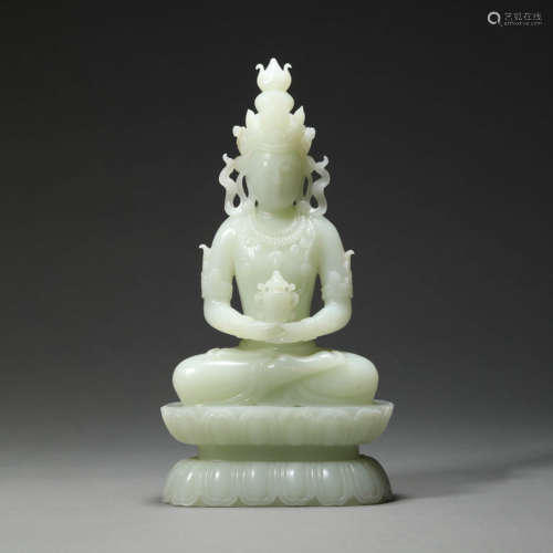 A WHITE JADE SEATED GUANYIN