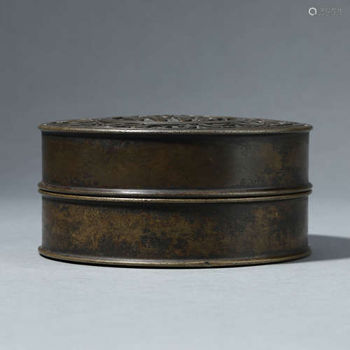 A BRONZE CIRCULAR BOX WITH COVER