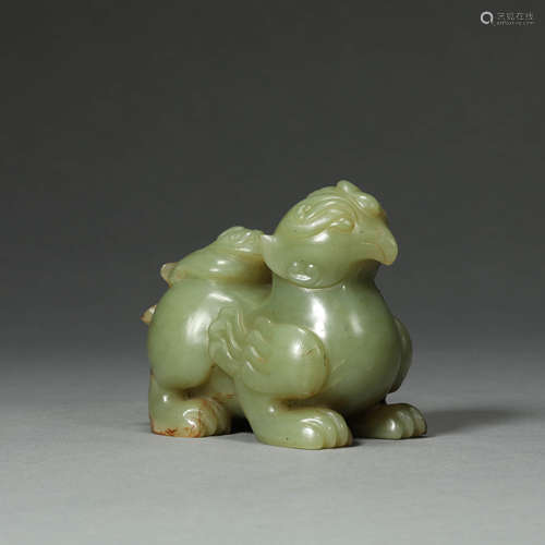 A CARVED CELADON JADE BEAST