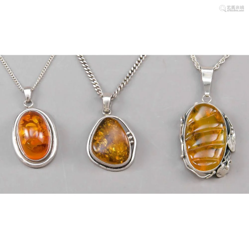 Three amber pendants with moun