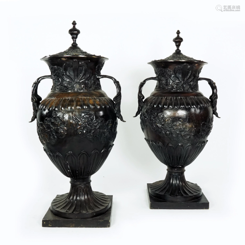 A pair of large patinated bronze vases and cover
