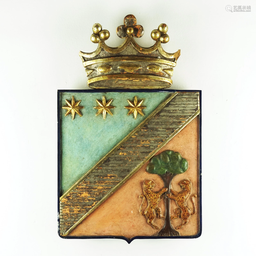 A lacquered, gilt and silvery carved wood coat of arm