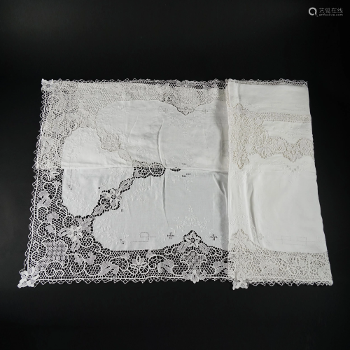 An hand embroidered white linen tablecloth with lace