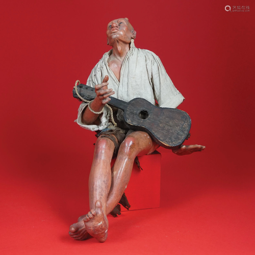 A crib figure of a bald beggar, late 18th-early 19th