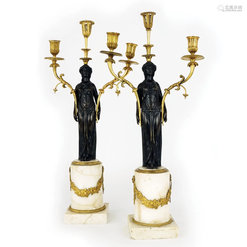 A pair of patinated and gilt bronze three-light