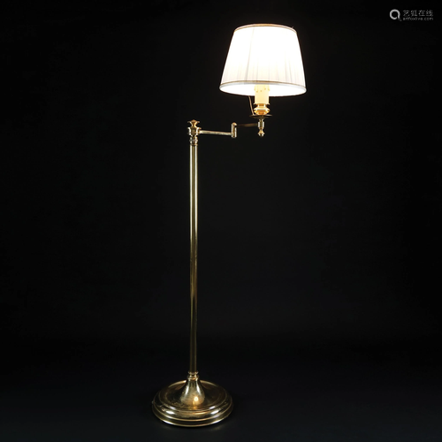 A brass floor lamp with extendable stem and adjustable