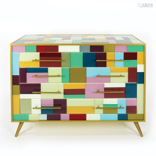 A multicolor glass covered commode with brass legs