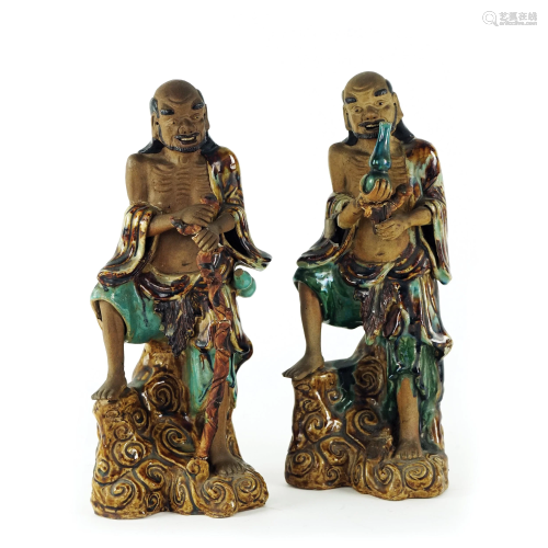 A pair of Chinese polychrome grès sculptures of a