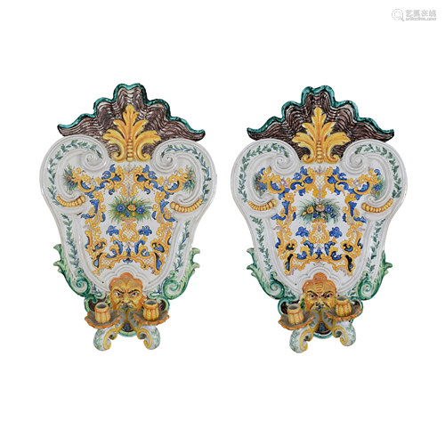 A pair of white and polychrome maiolica two-branch wall