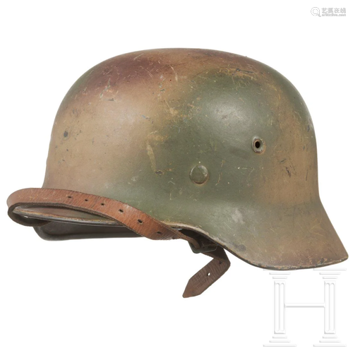 An army steel helmet M 40 with tri-colour camouflage