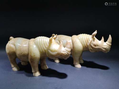 A PAIR OF CELADON JADE RHINO DESIGN FIGURINES