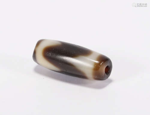 A TIGER TOOTH SHAPED DZI BEAD TIANZHU