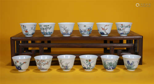 A SET OF 12 HAND-PAINTED PORCELAIN CUPS