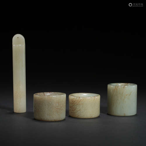 A SET OF HETIAN JADE THUMB RINGS AND JADE TUBE, QING DYNASTY...