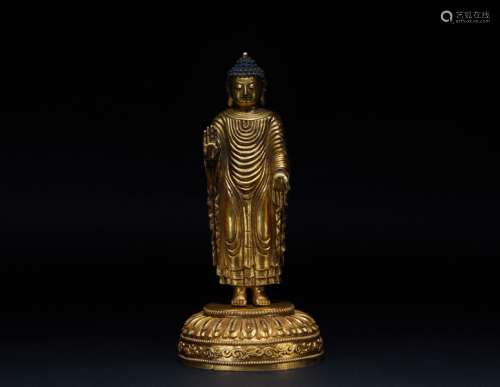 A gilt bronze statue of a standing Buddha in the Qing Dynast...