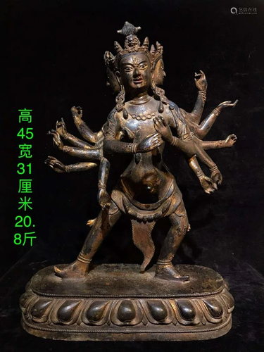 A bronze and gold multi-handed Buddha statue made in