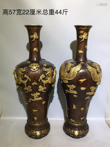 A pair of gilt bronze embossed dragon and phoenix vases