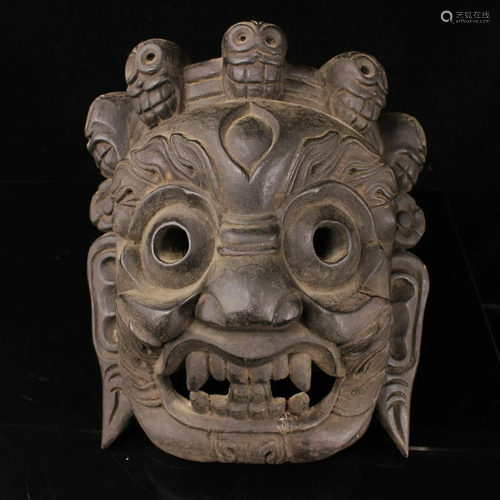 A collection of old wood hand-carved masks from the